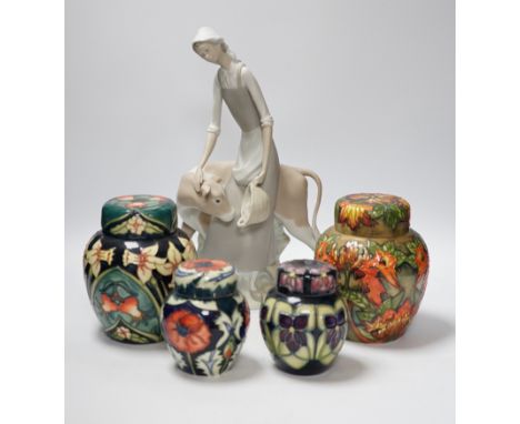 Four modern Moorcroft jars and covers, largest 16cm high, three boxed and a Nao figure group, tallest 95cm high