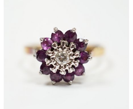 A modern 18ct gold, ruby and diamond cluster set flower head ring, size R, gross weight 4.2 grams.