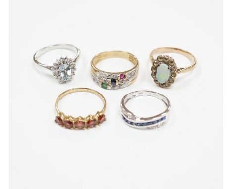 Four assorted 9ct and gem set rings, including opal and white sapphire?, blue topaz and diamond, sapphire and diamond chip cr