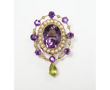 An early 20th century yellow metal, amethyst, peridot and seed pearl cluster set drop pendant brooch, 35mm, gross weight 4.9 