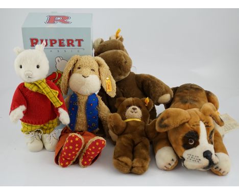 Four Steiff toys including Boxer dog and Rupert Bear