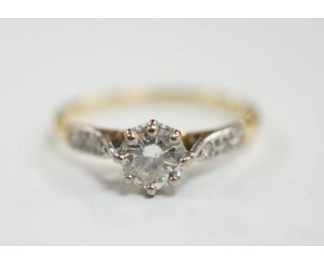 An 18ct and single stone diamond set ring, with diamond chip set shoulders, size M, gross weight 1.9 grams.