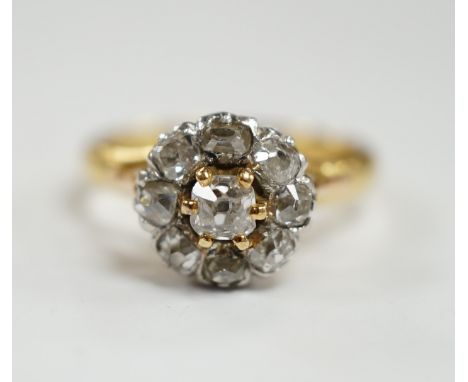 An early 20th century French 18k and nine stone diamond set flower head cluster ring, size G, gross weight 3.4 grams.