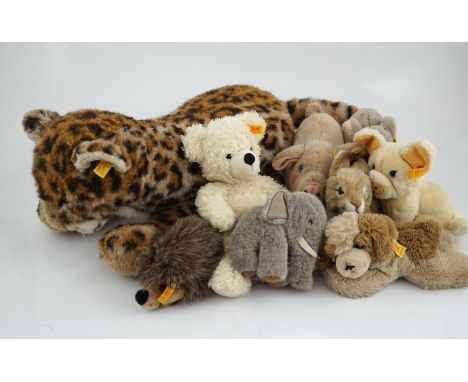 A large size Steiff yellow tag leopard, eight yellow tag animals, a Steiff button in the ear book and a book of Steiff postca