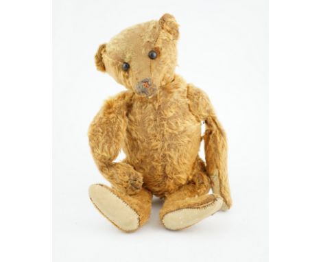 A cinnamon Steiff bear  c.1908, with button paw pads, stuffing missing in arms, hair loss to head, muzzle repaired, general h