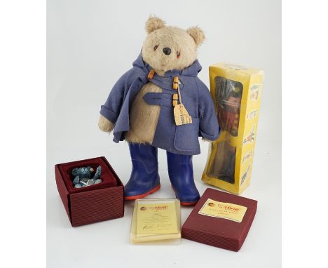 An early Paddington bear, blue jacket, missing hat, a Steiff Ltd. edition lilac bear in box, and a porcelain Pelham puppet in