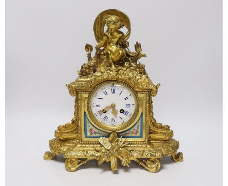 An early 20th century French ormolu mantel clock, with enamel dial, key and pendulum, 31cm
