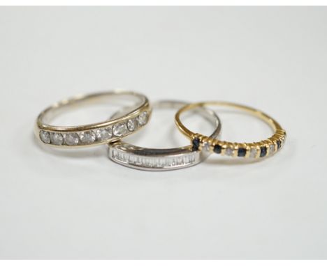 A white metal (stamped 950) and thirteen stone channel set baguette cut diamond ring, size O,  together with two other unmark