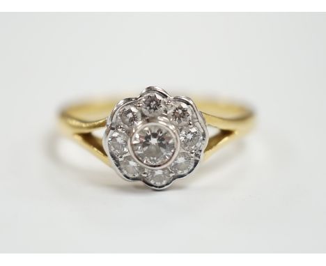 A modern 18ct gold and nine stone diamond set flower head cluster ring, size M, gross weight  3 grams.