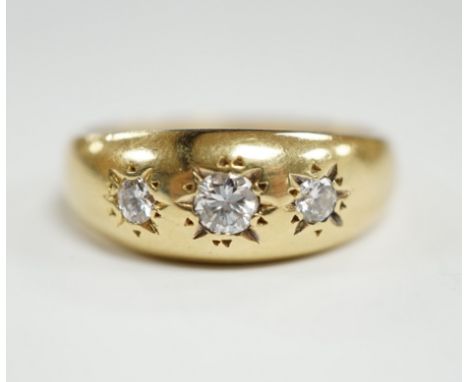 A modern 18ct gold and gypsy set three stone diamond ring, size S, gross weight 7.9 grams.