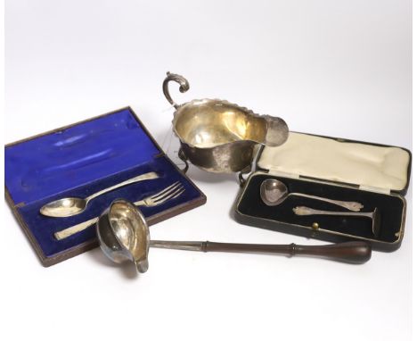 A small group of silver items to include a George V sauceboat, London, 1934, a George III toddy ladle, London, 1766 and later