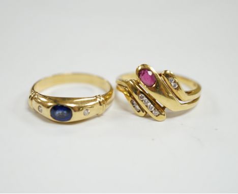 A modern 750 yellow metal and gypsy set single stone sapphire and two stone diamond set ring, size N, together with an Italia