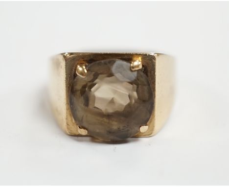 A 9ct gold and single stone oval cut smoky cut quartz set ring, size H, gross weight 4.5 grams.