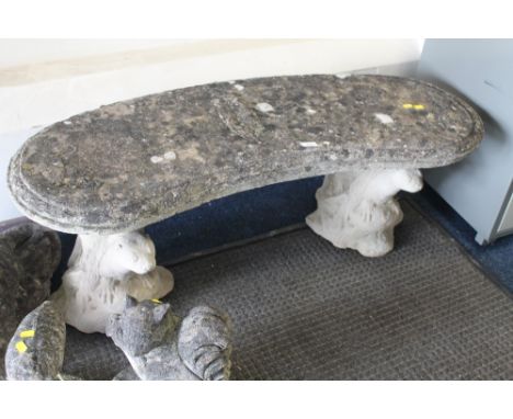 A STONE GARDEN BENCH WITH SQUIRREL PEDESTALS 
