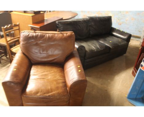 A LARGE BROWN CHAIR TOGETHER WITH A LARGE BLACK TWO SEATER SOFA 