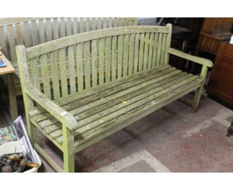 A LARGE WOODEN GARDEN BENCH