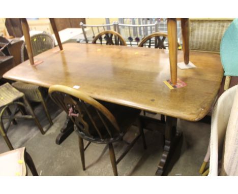 AN ERCOL STYLE DINING ROOM TABLE TOGETHER WITH THREE SPINDLE BACK CHAIRS 