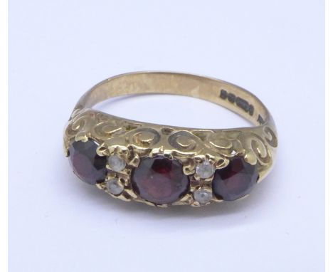 A 9ct gold, garnet and white stone ring, 2.8g, K