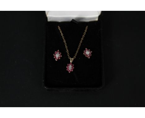 A ruby and diamond 9ct gold cluster pendant on chain with matching earrings