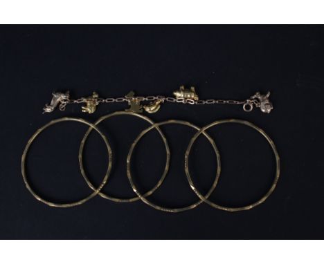 A yellow metal bracelet with six 9ct gold animal charms including enamelled dog, together with four yellow metal bangles