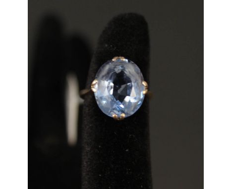 A 9ct gold ring set with faceted blue stone, size K