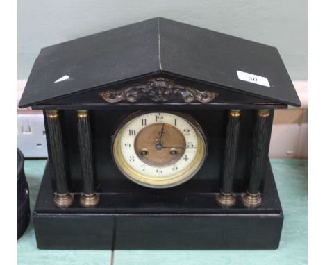 A black marble striking mantel clock