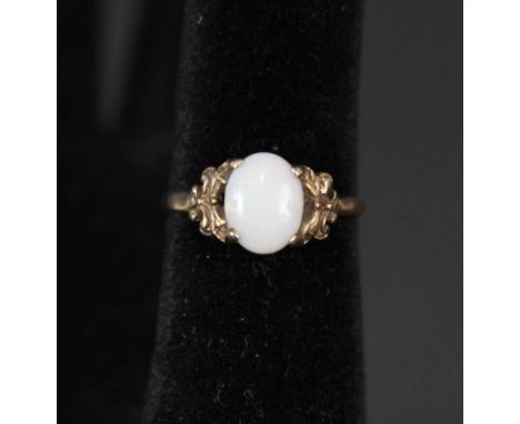 A 9ct gold opal ring with ornate setting, size N