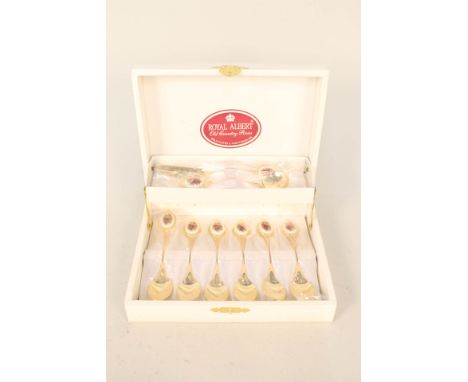 A boxed set of gold plated Royal Albert Old Country Roses spoons