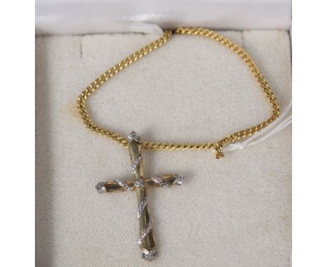 A 9ct yellow and white gold diamond set cross on 9ct gold chain