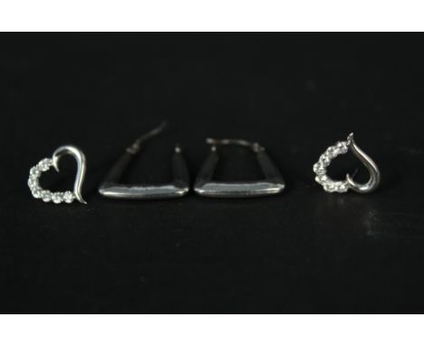 A pair of 9ct white gold hoop earrings and a pair of 9ct white gold heart shaped studs set with white stones