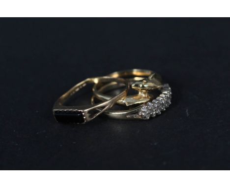 Two 9ct gold rings (one as found), one set with small white stones and a yellow metal dolphin design ring