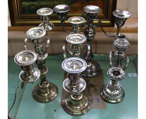 A pair of silver plated three light candelabra plus two others