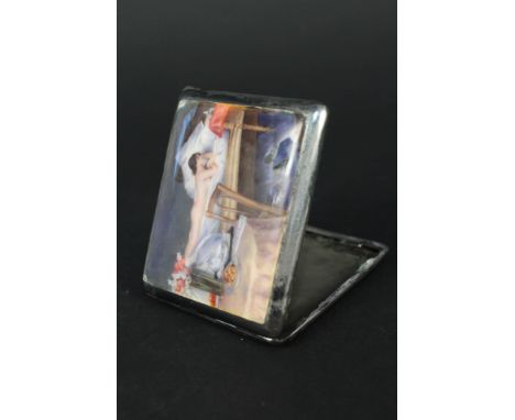 A silver cigarette case with enamelled scene of a nude lady lying in a bed to front (there are losses to the enamel and the c