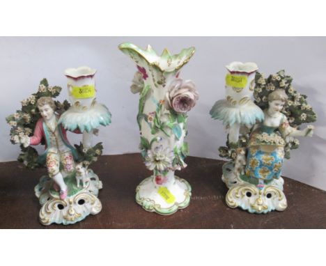 A pair of Continental porcelain candlestick, with figures and flowering tree, gold anchor mark, height 7ins, together with a 