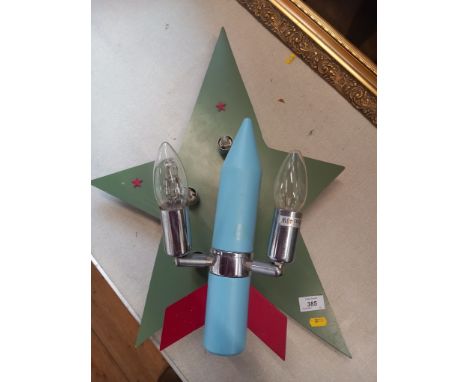 A wall light fitting, stylised as a rocket