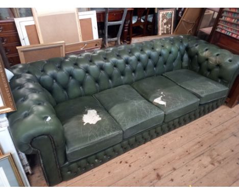 A green leather Chesterfield sofa