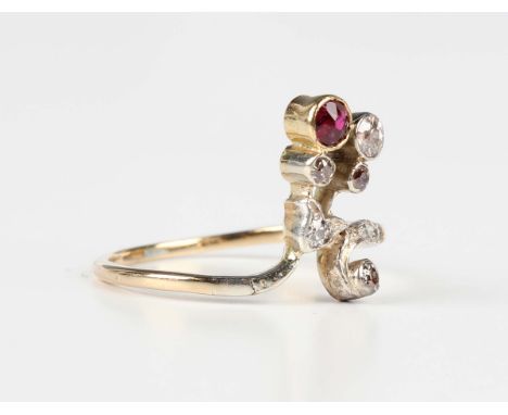 An Austro-Hungarian gold, diamond and ruby ring in a spray design, mounted with a cushion cut ruby, otherwise set with cushio