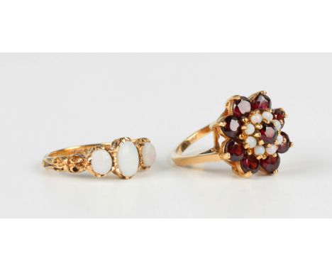 A 9ct gold, garnet and opal cluster ring, London 1971, ring size approx L, and a 9ct gold and opal three stone ring, London 1