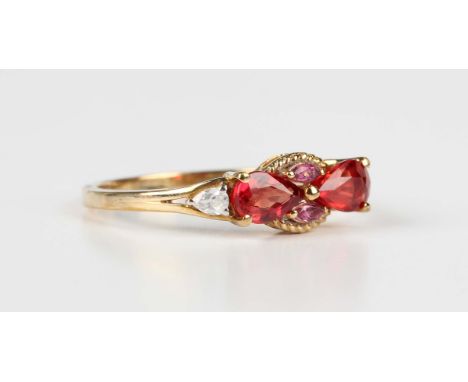 A 9ct gold ring, claw set with two pear shaped rubies, two pear shaped colourless zircons and two marquise shaped pink tourma