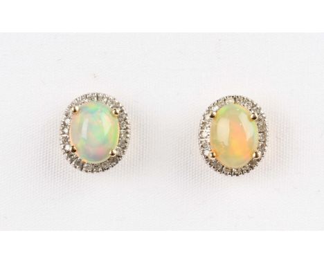 A pair of gold, opal and diamond earstuds, each claw set with an oval opal within a surround of circular cut diamonds, detail