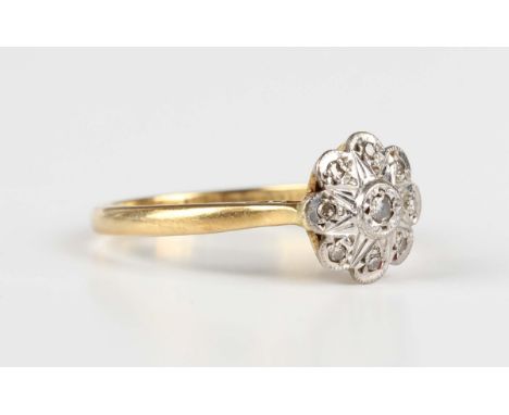 An 18ct gold and diamond nine stone cluster ring, mounted with circular cut diamonds in a flowerhead shaped design, Birmingha