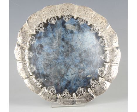 A late Victorian silver strawberry dish, the fluted rim chased with leaves and scrolls, London 1884 by William Comyns, weight