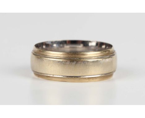 An 18ct gold wedding band ring with a textured finish, London 1983, weight 3.3g, ring size approx J.Buyer’s Premium 29.4% (in