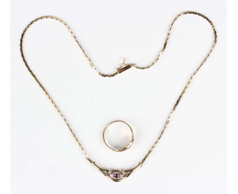 A 9ct gold, ruby and diamond three stone necklace, the front mounted with a circular cut ruby between two circular cut diamon