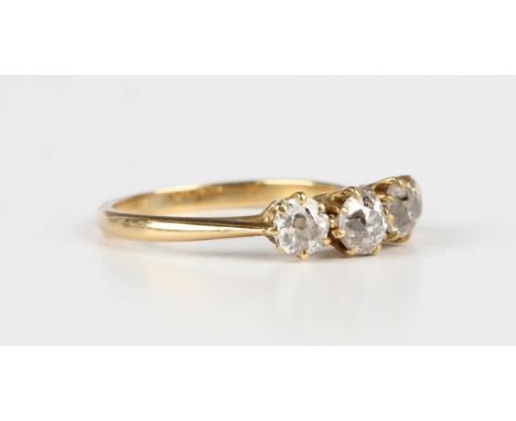A gold ring, claw set with a row of four cushion cut diamonds, unmarked, weight 2.5g, ring size approx M.Buyer’s Premium 29.4