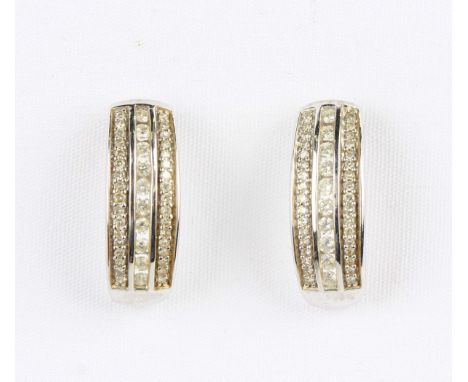 A pair of 9ct white gold and diamond earrings in a curved design, with post and butterfly fittings, detailed '375 0.25', weig