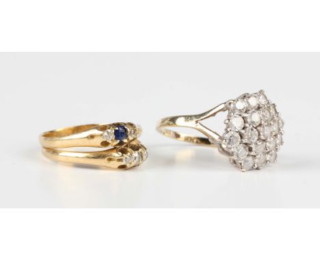 An 18ct gold, diamond and sapphire ring in a twin three stone shank design, mounted with five cushion cut diamonds and a sing