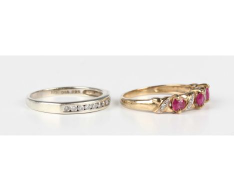 A 9ct gold, ruby and diamond ring, claw set with three circular cut rubies alternating with four circular cut diamonds, ring 