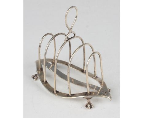A late Victorian silver four-division toast rack with loop handle, raised on claw and ball feet, London 1894 by William Hutto