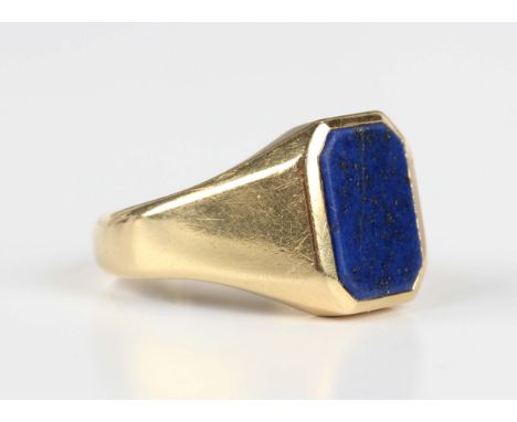 A gold and lapis lazuli cut corned rectangular signet ring, detailed '18', fitted with a sizing band, weight 13.7g, ring size